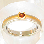 Platinum and 18 Karat Yellow Gold 2-tone matte-finished heavy band with natural-colored round orange diamond in 18 Karat Yellow Gold full bezel setting