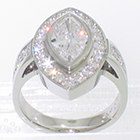 Platinum "Halo" ring with Marquise-shaped diamond surrounded by bead-set melee round diamonds with bead-set round melee diamonds on cathedral shank