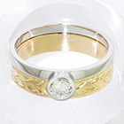 Platinum solitaire ring with half-overhanging bezel to allow a band to fit underneath (pictured with flat hand-engraved 14 karat yellow gold band)