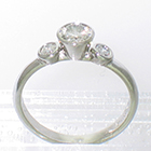 Platinum 3-stone ring with round diamonds in high-profile bezel settings