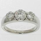 Platinum 3-stone ring with round brilliant diamonds set in 6-way-cut semi-bezel settings on heavy round shank