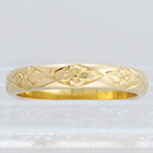 14 Karat Yellow Gold half-round band with diamond-shaped all-around flower pattern
