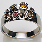 Platinum "coney" ring with natural fancy colored diamonds in tapered bezels