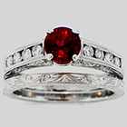 Hand-engraved Platinum wedding set with 1.23 carat round Ruby in 4-prong setting with 0.40carats total weight of round diamonds channel-set in sides and matching hand-engraved platinum band.