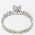 Platinum solitaire ring with Ascher-cut diamond in fancy "fishtail" style setting on hand engraved pinched shank