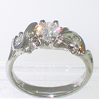 Platinum "ivy" ring with round brilliant diamond set in freeform 6-prong setting with round melee diamonds set around ivy vines