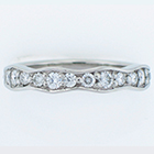 Palladium wavy band with bead-set diamonds.