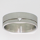 Palladium flat band in matte finish with flush-set princess-cut diamond alligned corner-to-corner in sunken polished lathe line