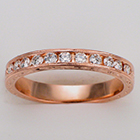 14 karat rose gold hand-engraved band with 0.50 carat of round channel-set diamonds.