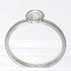 Platinum stacker ring with 0.40 carat rose-cut diamond in full polished bezel with cut-outs to allow band to slide under setting. brushed finish on band