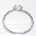 Platinum stacker ring with 0.40 carat rose-cut diamond in full polished bezel with cut-outs to allow band to slide under setting. brushed finish on band