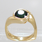14 Karat Yellow Gold wrap-around-bezel style ring with round Green Sapphire