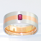 Brushed Platinum band with 14 karat rose gold inlay and flush-set emerald-cut ruby.