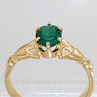 14 Karat Yellow Gold Celtic Solitaire ring with Oval-shaped emerald in 6-prong crown-style setting