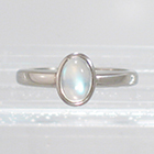 Palladium solitaire ring with oval-shaped caboschon-cut moonstone in full bezel setting (alternate view)