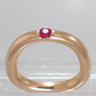 14 Karat Rose Gold barstock band with flush-set round ruby