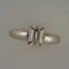 platinum 4-prong emerald-cut diamond ring with rounded shank