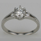platinum hand-engraved split-shank ring with round diamonds.