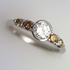 platinum ring w/a 1ct. &#34;e&#34; color diamond and 4 natural colored diamonds