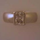 platinum heavy-shank ring (brushed) with rectanular radiant-cut diamond in bracket-style semi-bezel (polished).